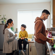 couple with child in a kitchen